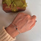Adjustable silver kada featuring black onyx and crescent moon charm