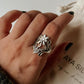 Exquisite chunky silver ring featuring a detailed floral garden motif.