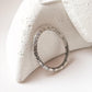 Tribal Edge 925 silver ring displayed on a textured surface, showcasing intricate designs and unique craftsmanship.