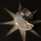 Sacred Journey 925 silver ring displayed on a crescent-shaped stone, showcasing its intricate design and craftsmanship.