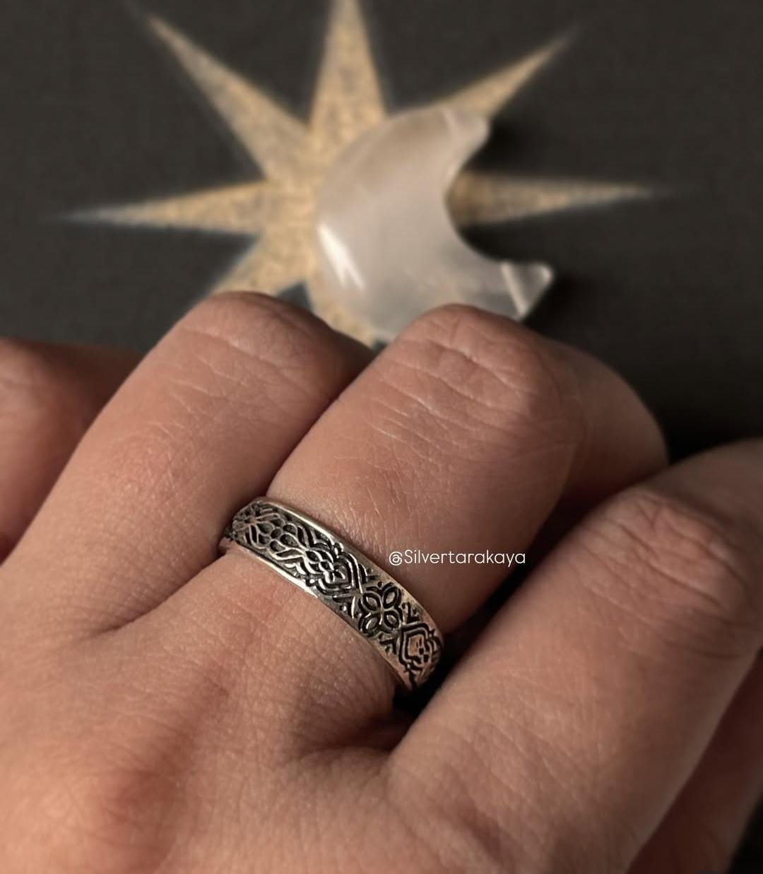 925 silver ring with intricate floral design worn on a hand, showcasing a unique and handmade jewelry piece.