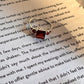 Sterling silver ring with a square-cut garnet in a vintage setting