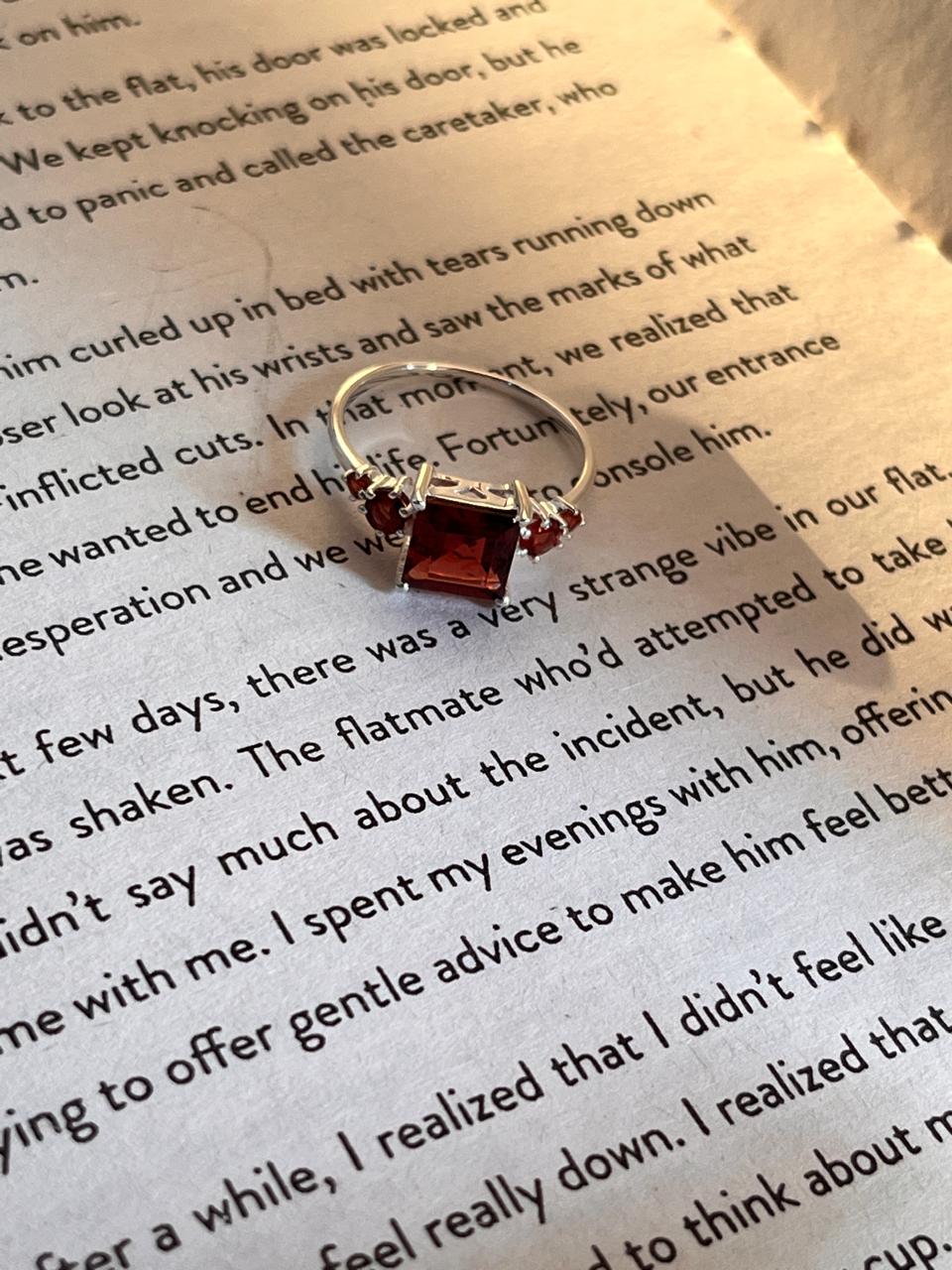 Sterling silver ring with a square-cut garnet in a vintage setting
