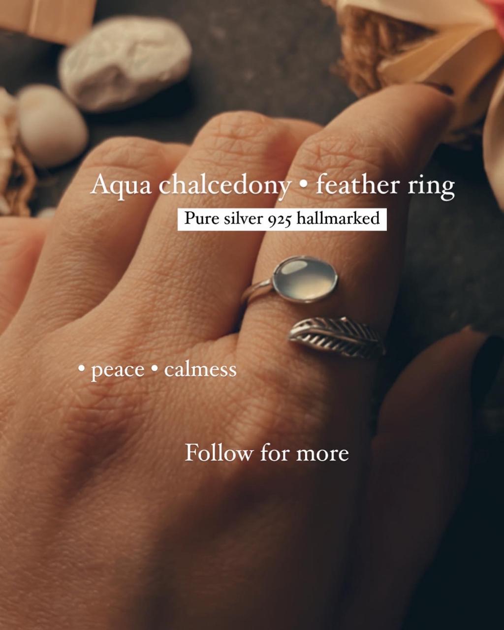 Aqua chalcedony stone set in an adjustable silver ring with feather detailing.