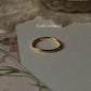Gold vermeil plain round stack band ring on soft background, showcasing its elegant design and durability.