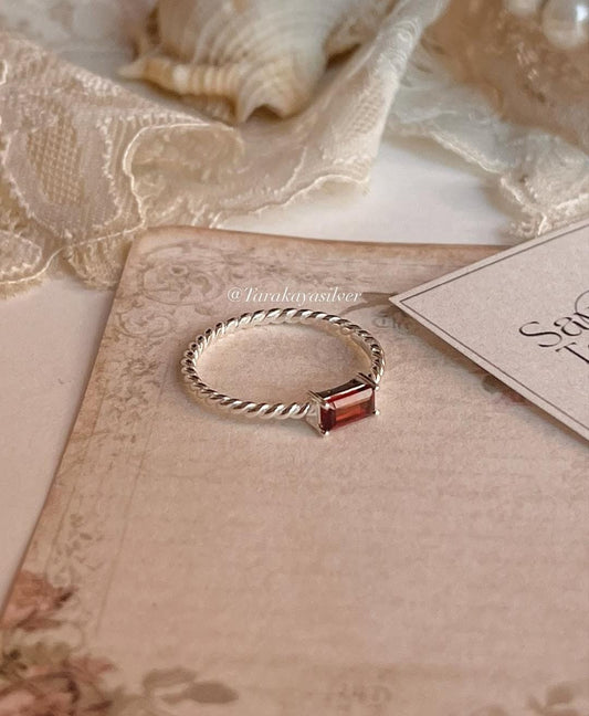 Sterling silver rope band ring with garnet baguette cut