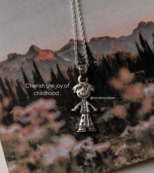 Handcrafted silver pendant with little boy charm