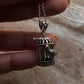 Hand holding a 3D silver pigeon pendant in a cage, crafted from pure silver 925, perfect for thoughtful gifts.