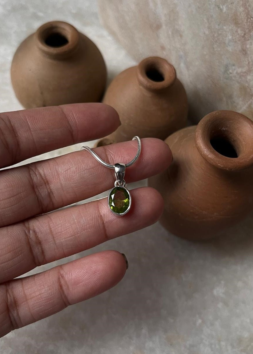 Elegant Oval Peridot Pendant in Silver Setting