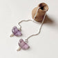 Threader earrings with freshwater pearl and amethyst butterfly charm