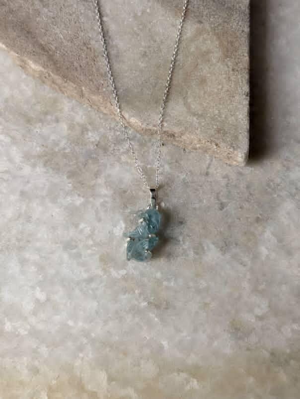 Nature-themed aquamarine pendant with silver detailing  
