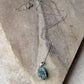 Handcrafted aquamarine pendant with forest-inspired design  