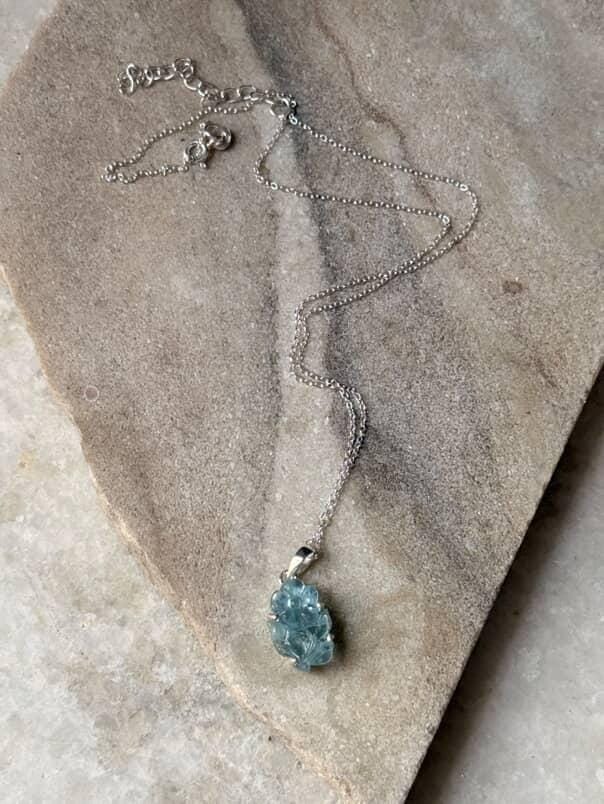 Handcrafted aquamarine pendant with forest-inspired design  